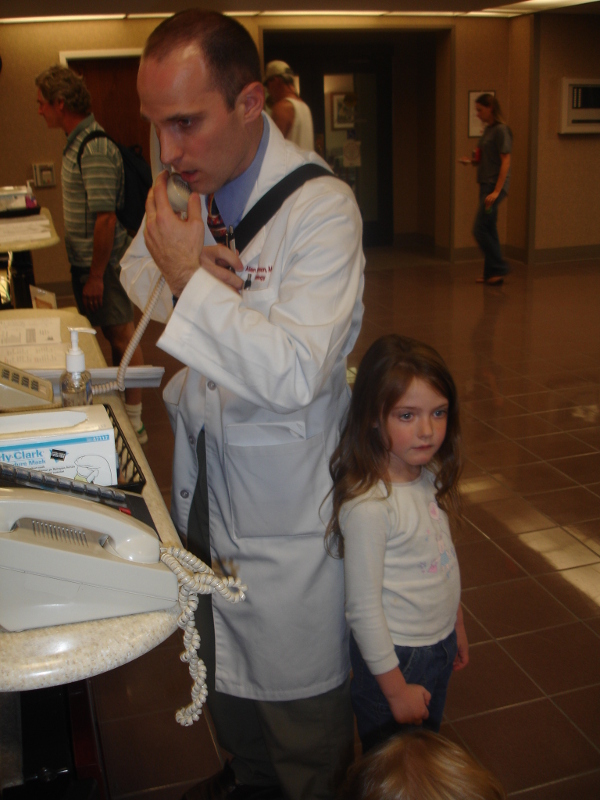 doctor on phone wearing white coat-600x800